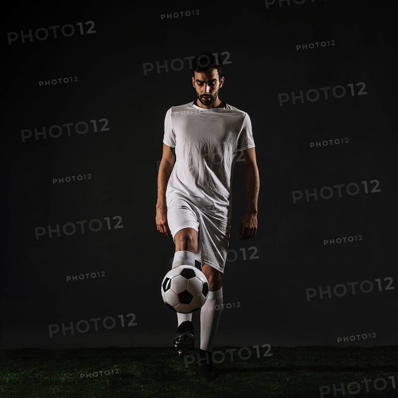 Handsome sportsman juggling ball