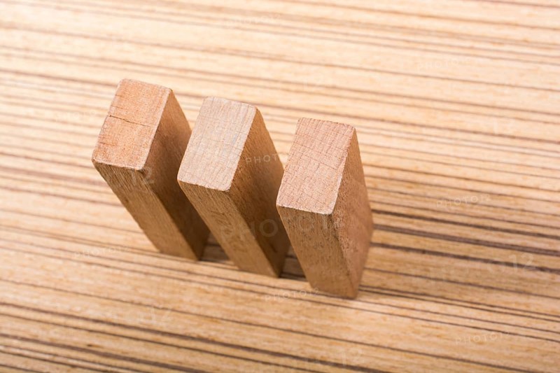 Piece of domino elements made of wood on wooden texture