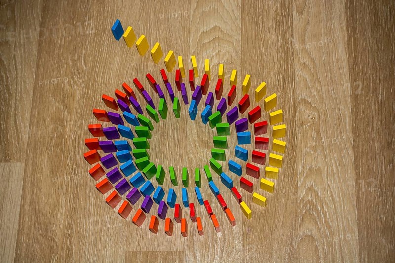 Colorful Domino Blocks in a line on a white background