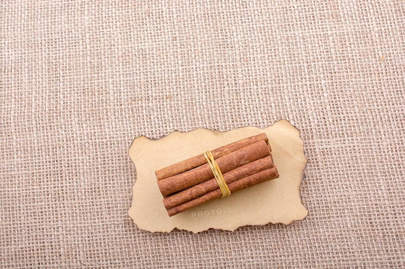 Bundle of cinnamon sticks on a linen canvas background