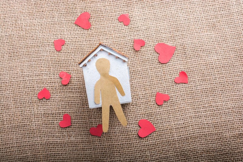 Heart shaped icons and paper house on canvas