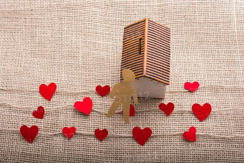 Heart shaped icons and paper house on linen threads