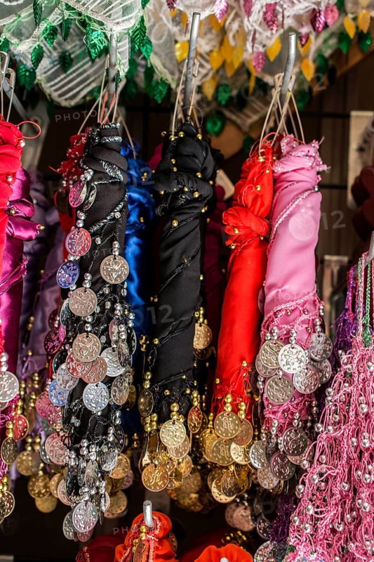 Plenty of fake gold coins are on the scarf edges