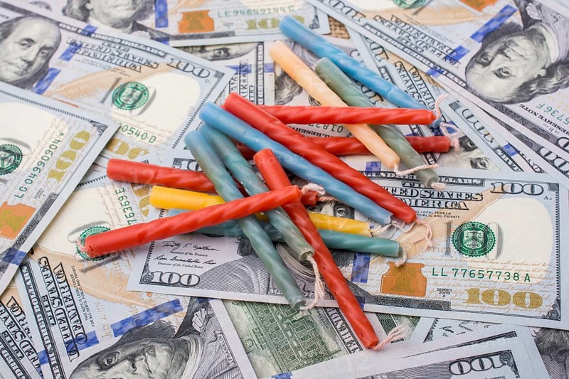 Birthday candles is placed on spread US dollar banknotes