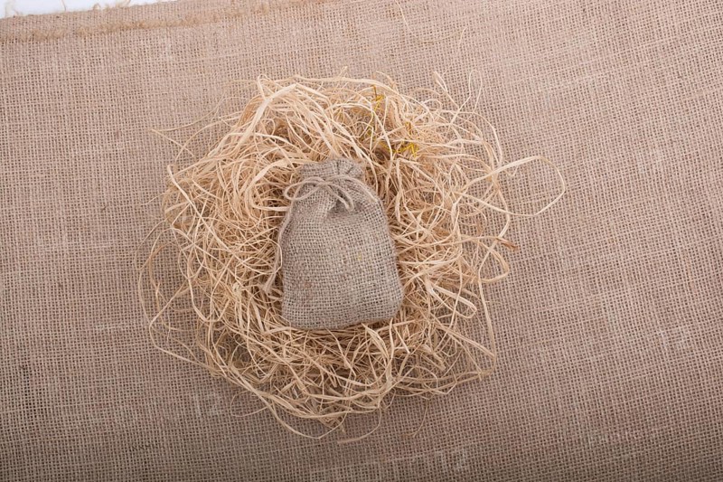 Sack placed on straw on canvas background