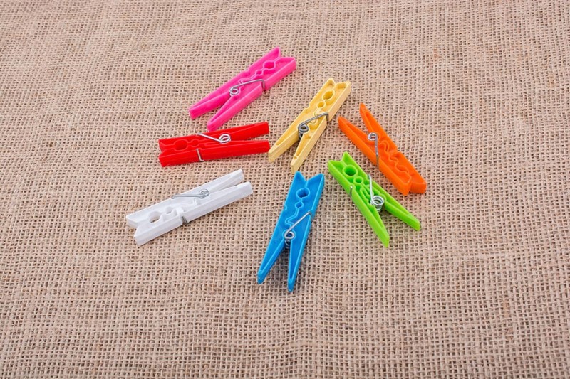Clothespins placed on a linen canvas background