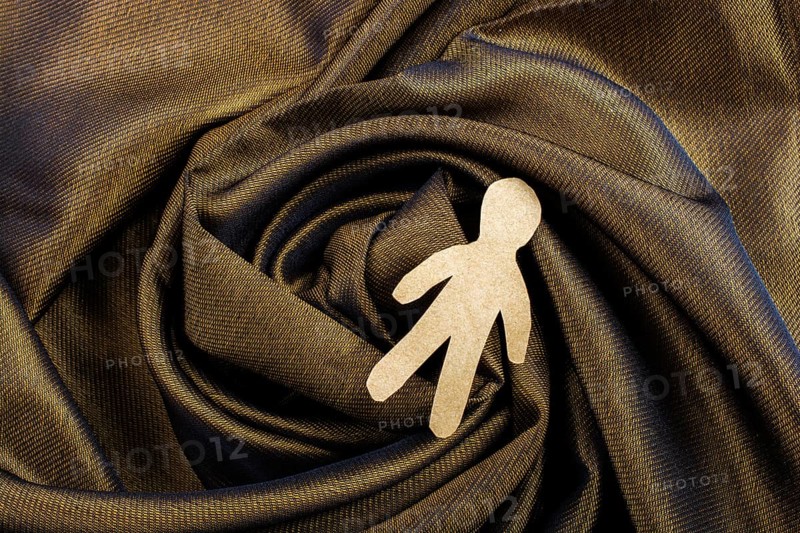 Man shape cut out of paper in hand in the view