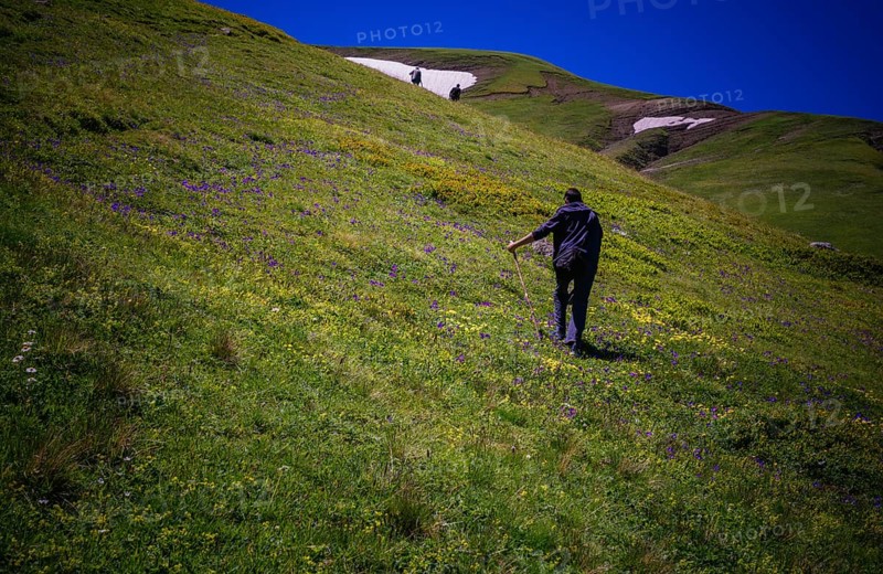 Hikers with backpacks and trekking poles walking in Turkish highland