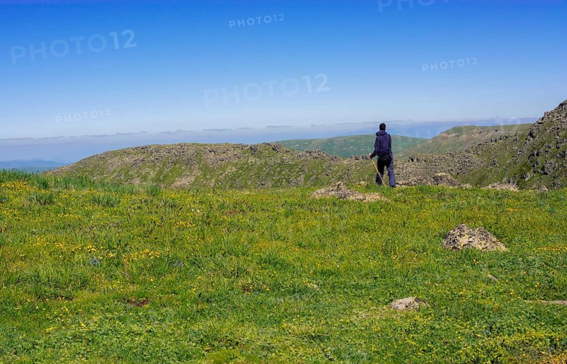 Hikers with backpacks and trekking poles walking in Turkish highland