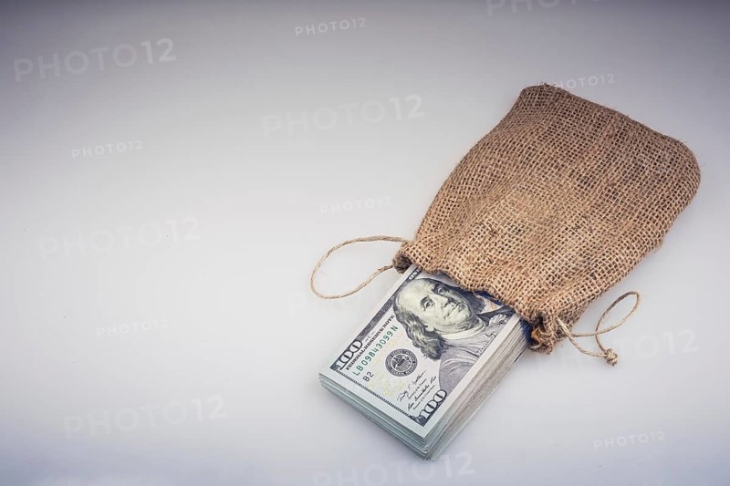 Banknote bundle of US dollarin a sack on a white background