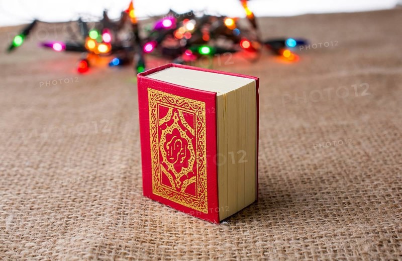 Islamic Holy Book Quran with lights behind
