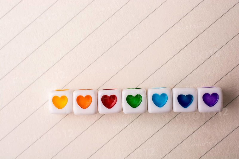 Colorful cubes with a heart placed on paper