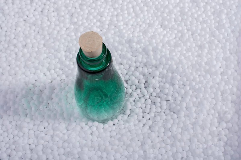 Empty bottle on little white polystyrene foam balls