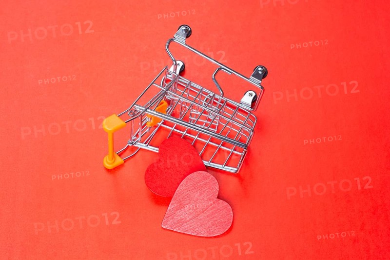 Red hearts and shopping cart. Valentines Day background. Greeting card for holiday