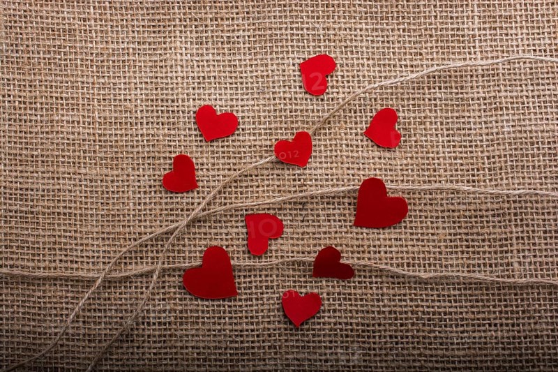 Love concept with heart shaped papers on linen threads