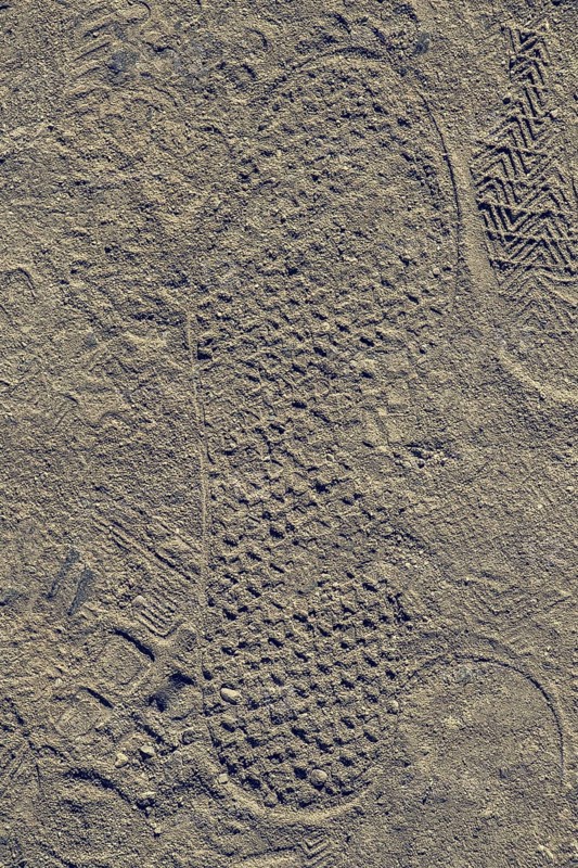 Footstep on sand stones textured as abstract grunge background