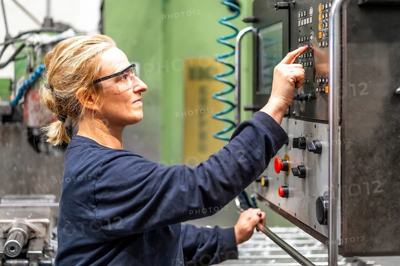 Female factory worker operator working in numerical control sector