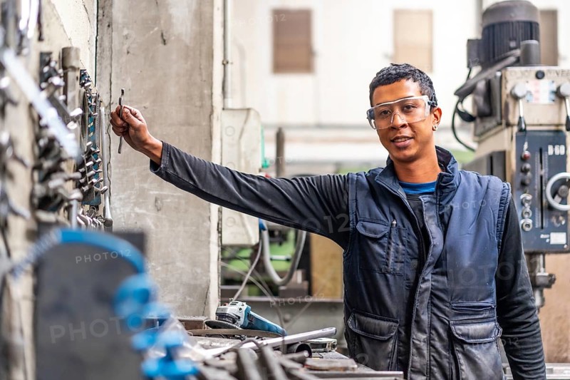 Latino worker in the metal industrial factory trade in the numerical control sector
