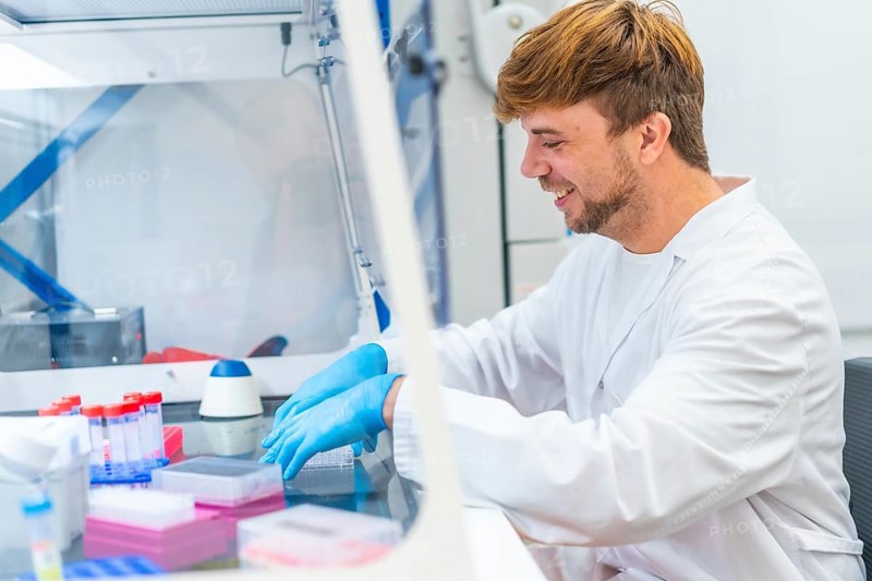 Young scientist working on cells in a cancer research and infectious diseases laboratory