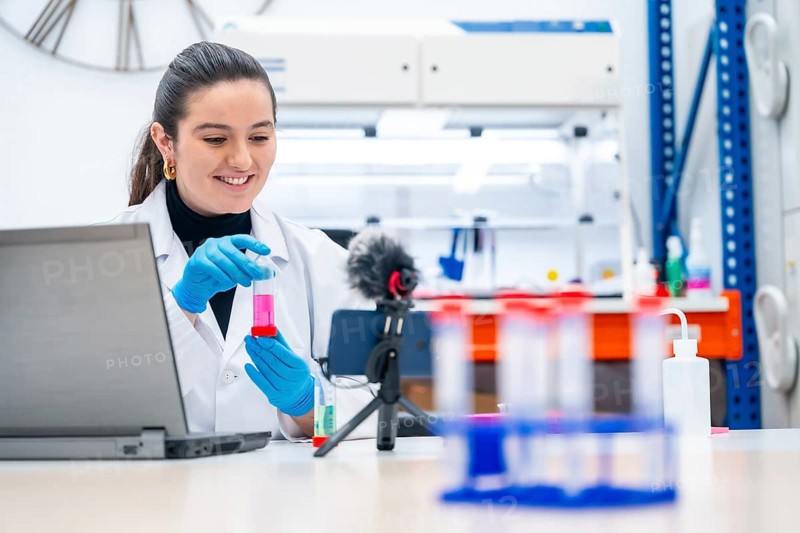 Young female biologist recording a video showing samples in a research laboratory