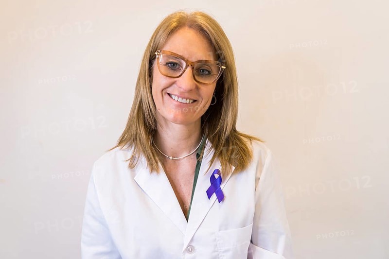 Female doctor using breast cancer awareness ribbon