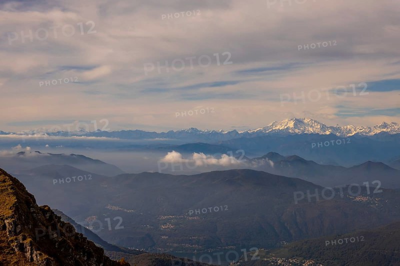 Aerial View over a Beautiful Mountainscape and And Snow Capped Monte Rosa and Mountain Peak Matterhorn and with Floating Clouds in a Sunny Day in Ticino