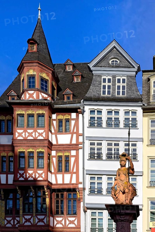 Fountain representing roman goddess Minerva in front of colorful Half-timbered houses in Roemerberg square