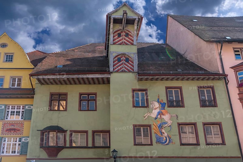 Historic town house with tower and mural painted by Bernhard Waeschle in 1954