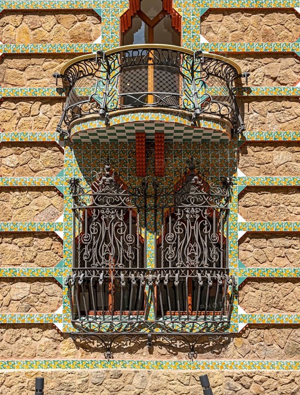 Window with wrought iron grille and upper balcony