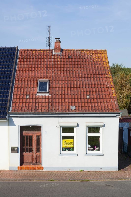 Old house with sign for sale