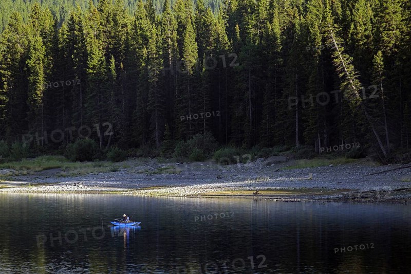 Angler in blue inflatable pontoon fishing boat at Lower Kananaskis Lake