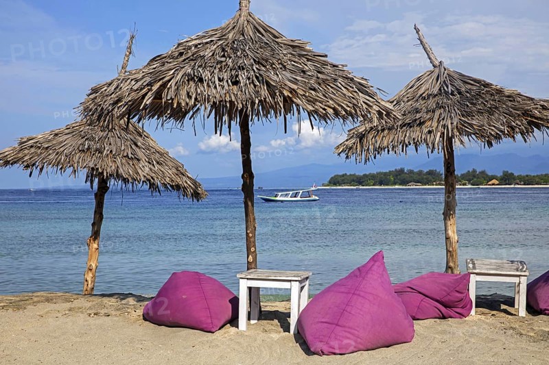 Parasols of beach restaurant on the island Gili Trawangan