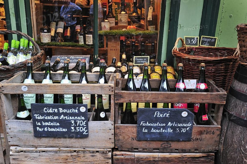 Regional products like cider and bottles of calvados in shop at Honfleur