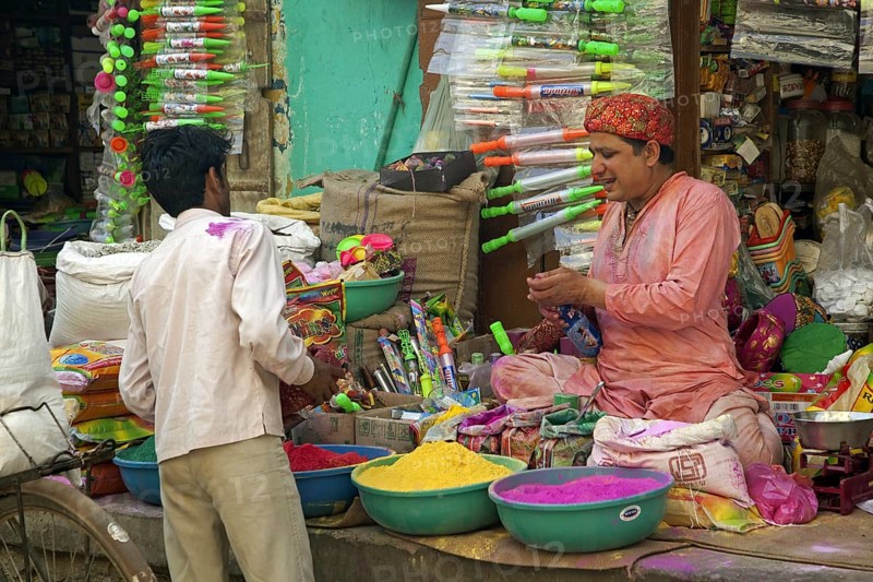 Vendor selling colourful powder to use as dye for the Holi festival