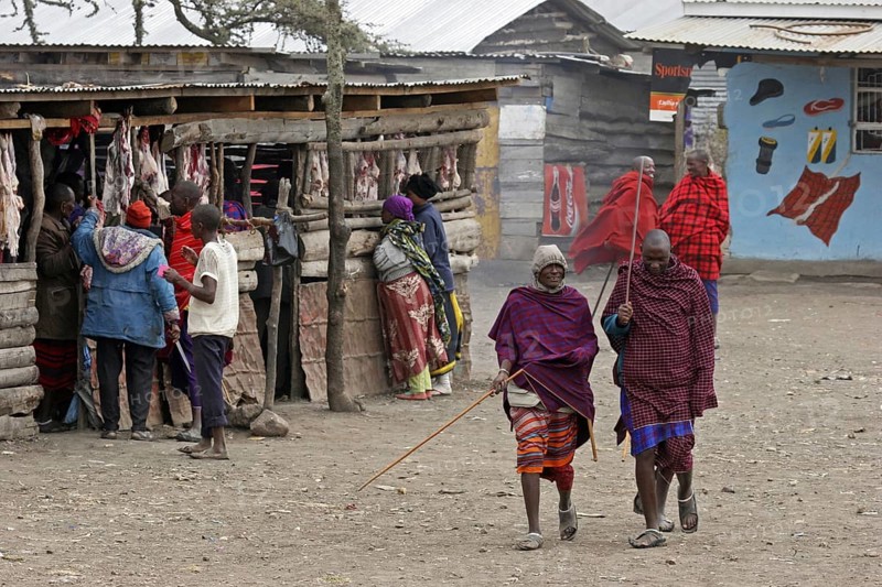 Maasai men walking in the street in village