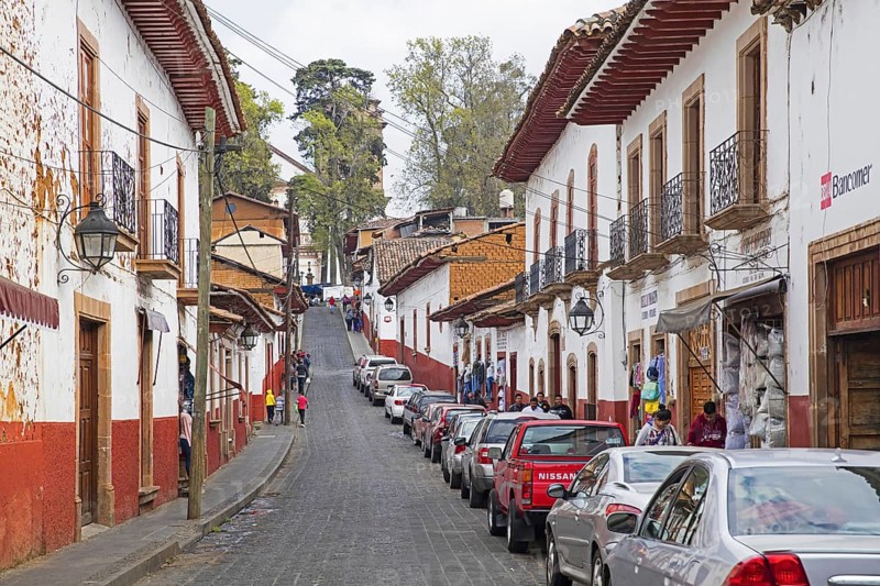 Traditional colonial-indigenous red and white adobe houses and shops in the town Patzcuaro