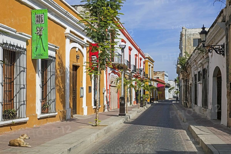 Shops in colourful street with colonial buildings and houses in the city Mazatla? n