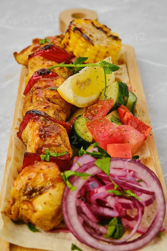 Chicken skewer served with pickled vegetables