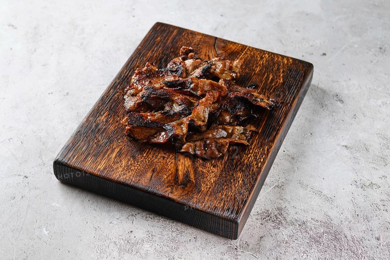 Serving board with fried beef bacon strips