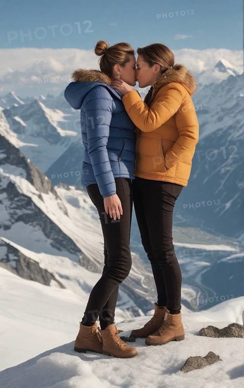 Elegant fashionista gay couple kiss on the top of the swiss alps