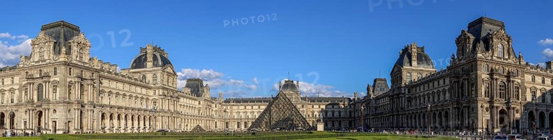 Panoramic photo of the Louvre Museum building and the glass pyramid
