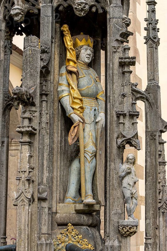 Detail with the portrait of the prince sculpture on the Gothic fountain column of the market fountain on the market square