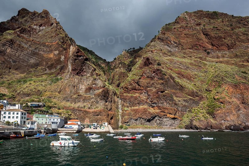 Boat harbour with boats and cliffs