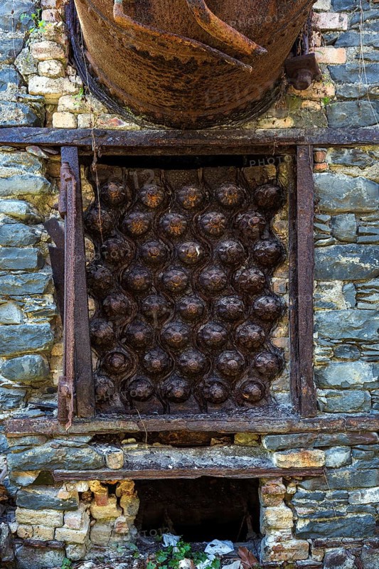 Rusted pressure vessel and bolts on a disused factory site