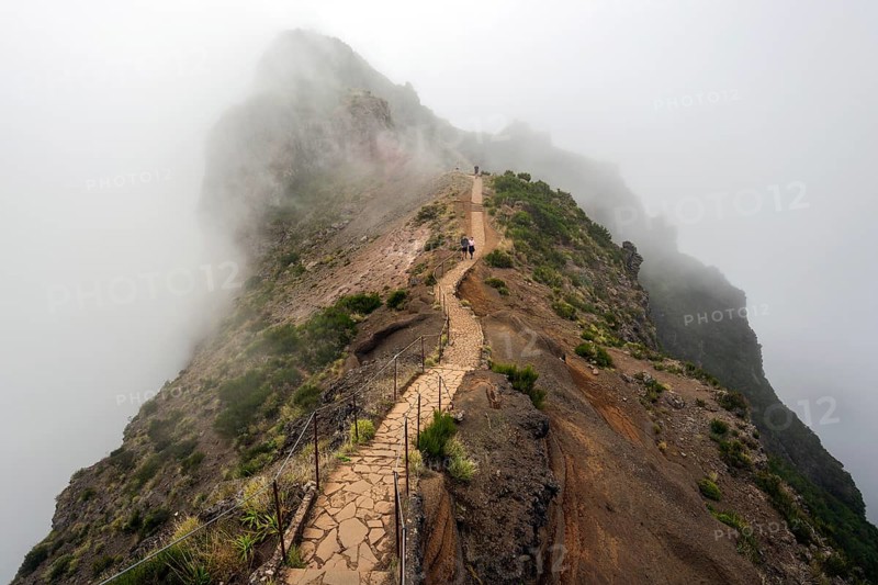 Hikers on the PR1 Vereda do Areeiro hiking trail in the fog