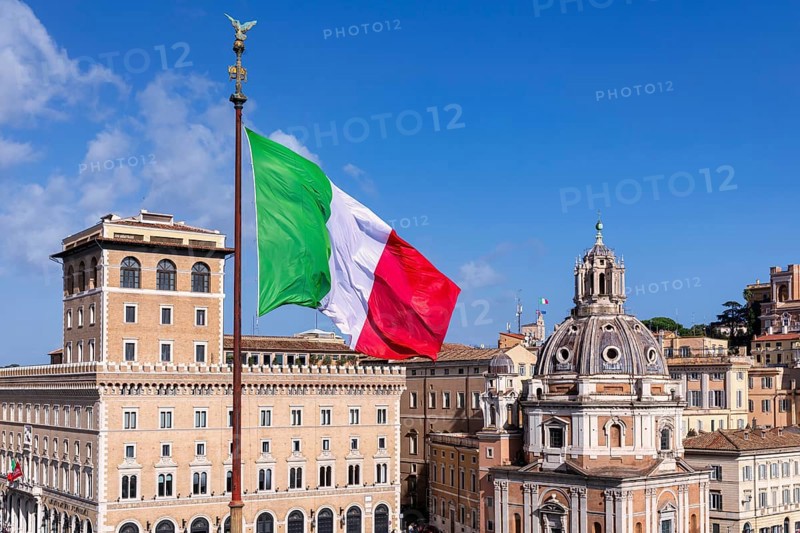 The Italian flag seen in front of the Church of Santa Maria di Loreto al Foro Traiano on the right
