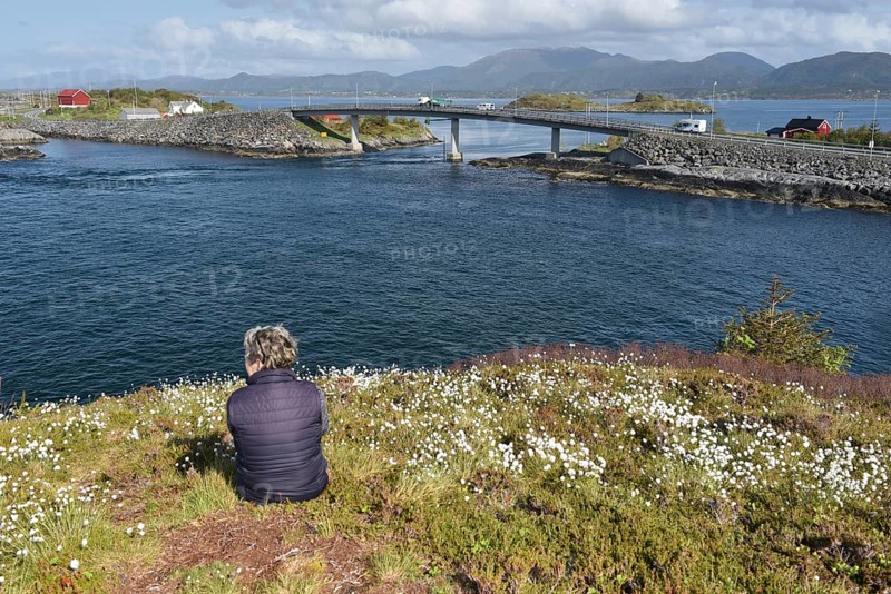 Woman sitting on the Atlantic Road in Norway