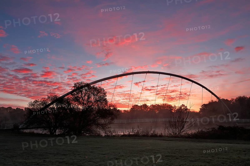 Bridge over the river Mulde near Dessau-Rosslau in the morning with atmospheric cloudy sky