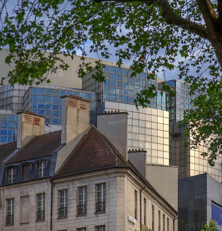 Historic houses in front of the modern Paris Opera