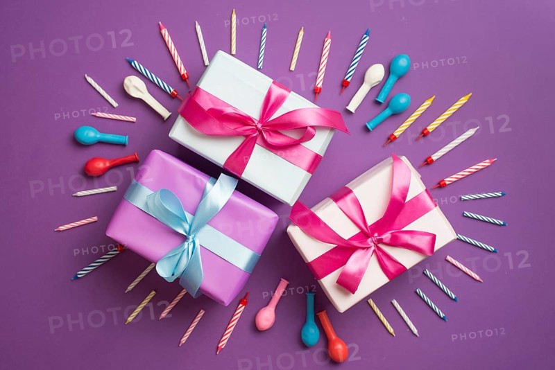 Gifts surrounded by candles balloons